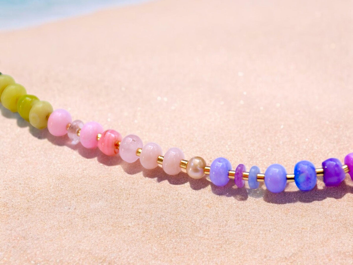 This multi gemstone necklace is handmade, featuring an array of vibrant, rainbow gemstones. From rich amethysts and fiery citrines to lush jades and serene chalcedony.