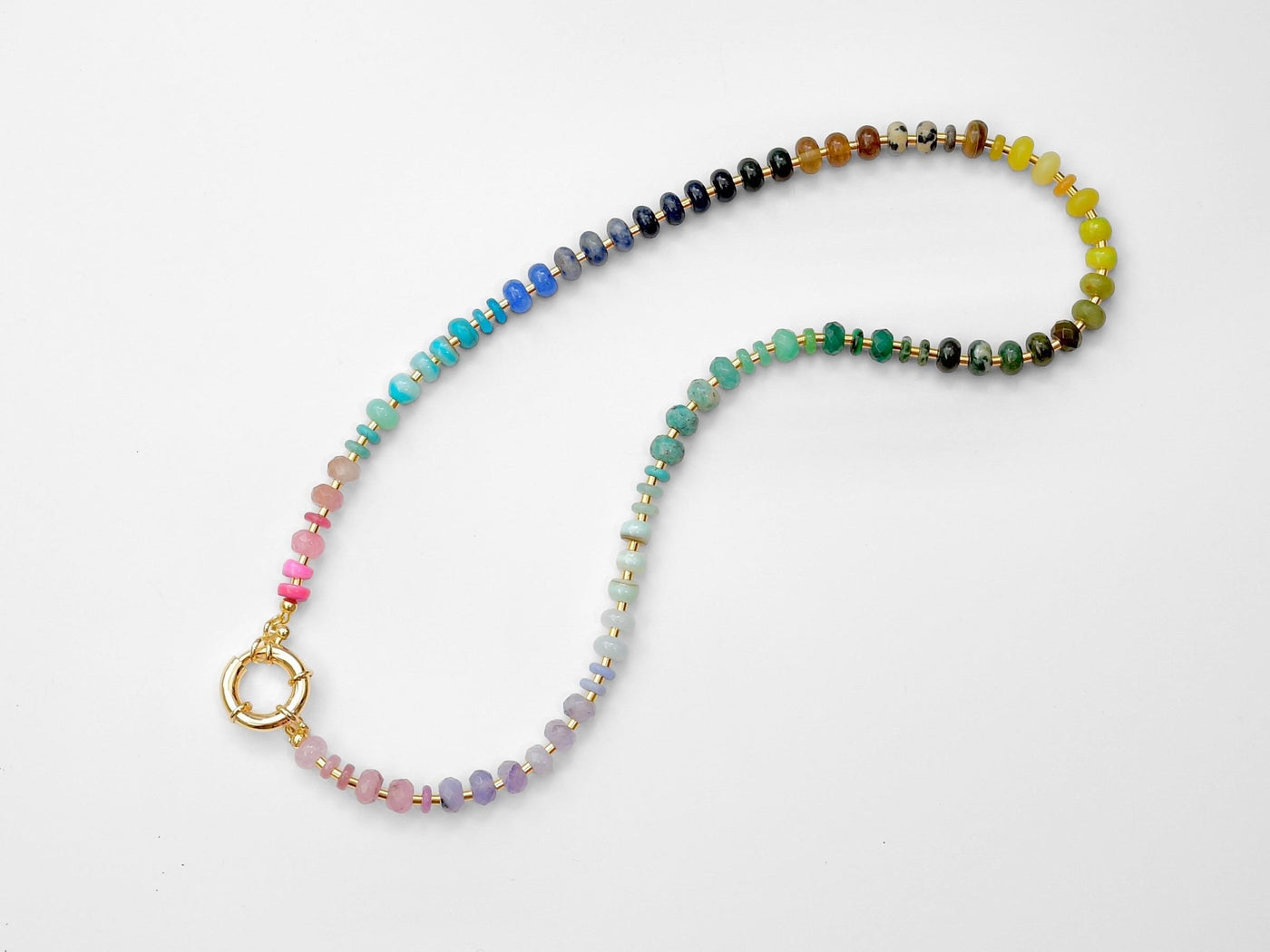 This multi gemstone necklace is handmade, featuring an array of vibrant, rainbow gemstones. From rich amethysts and fiery citrines to lush jades and serene chalcedony.