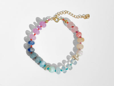 A beautiful pastel colored gemstone hand-knotted bracelet. Hues are rainbow pastels. Natural gemstones hand-knotted with a rainbow ombre thread. It&#39;s perfect to wear alone or stack with other bracelets.