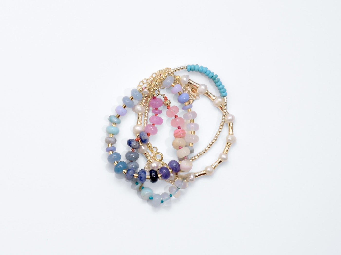 A beautiful pastel colored gemstone hand-knotted bracelet. Hues are rainbow pastels. Natural gemstones hand-knotted with a rainbow ombre thread. It&#39;s perfect to wear alone or stack with other bracelets.