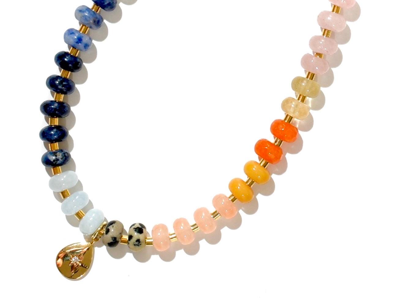 Multi mixed gemstone necklace in earthly jewelry tones. It features gold spacing tube beads that add a hint of shimmer and elegance to the overlook appeal. It has deep oranges, yellows, greens, and browns which tell a vibrant story of a late july.