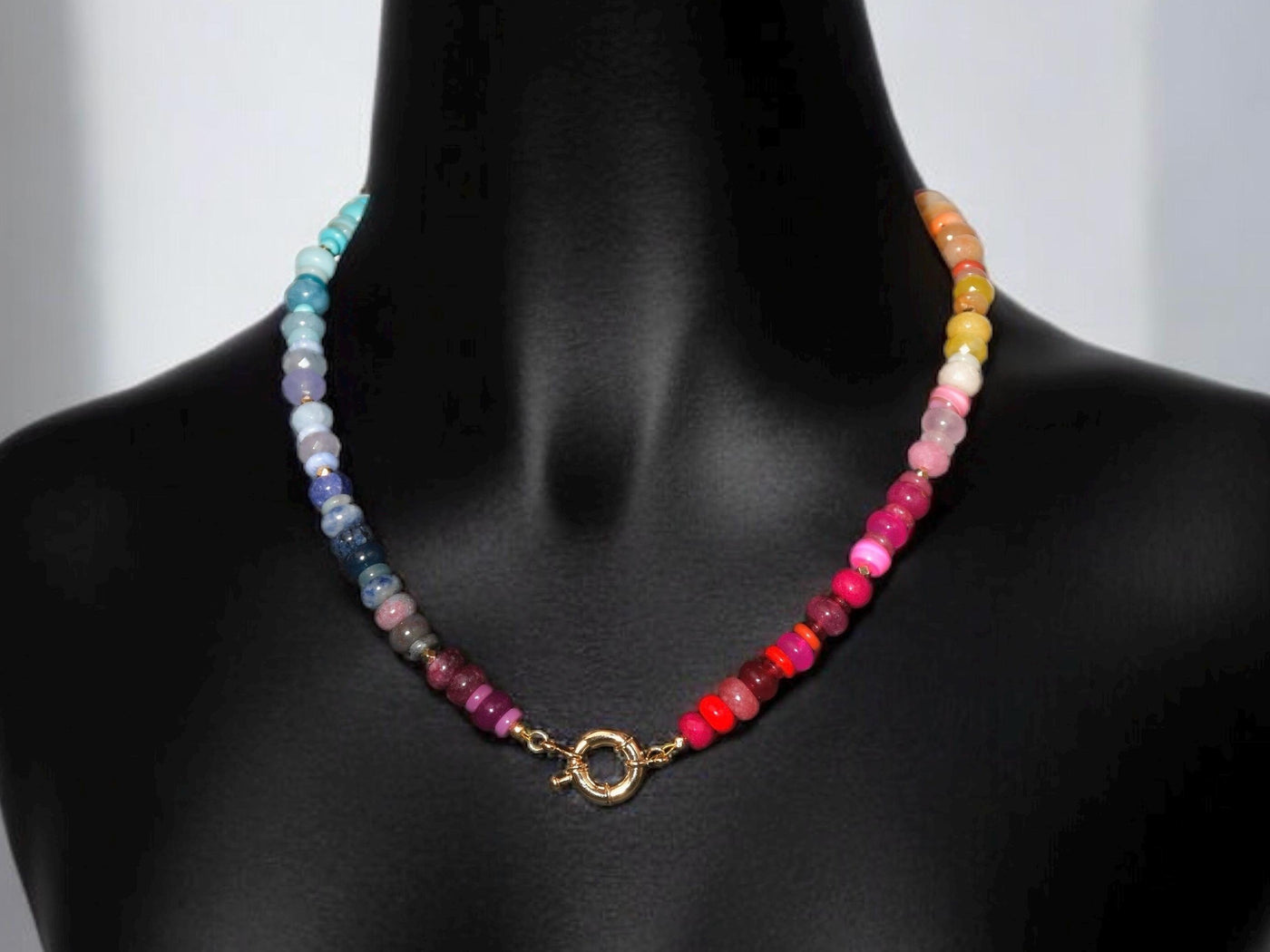 Multi mixed gemstone necklace in bright, jeweled colors . It features gold spacing tube beads that add a hint of shimmer and elegance to the overlook appeal.