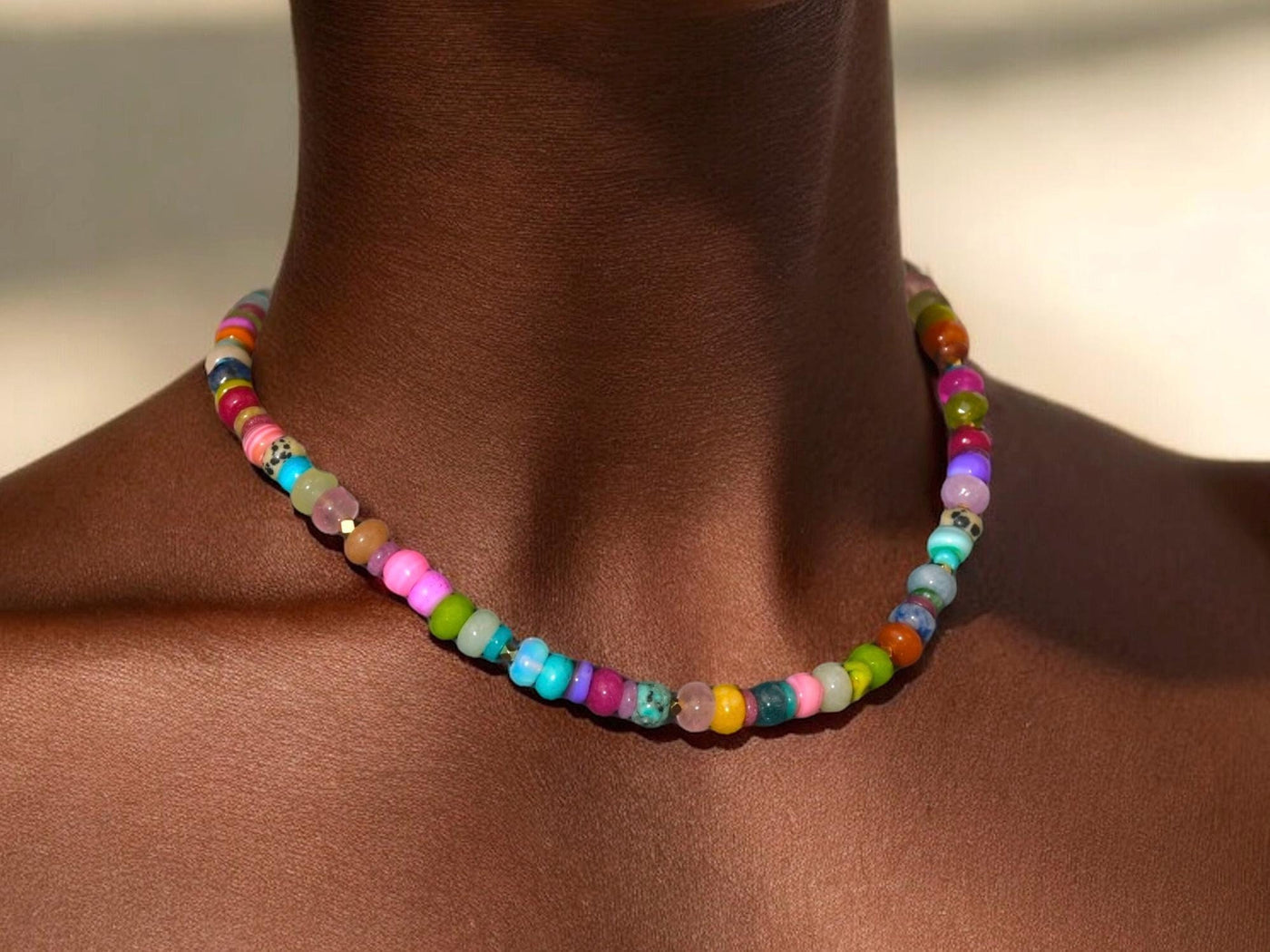 A fun rainbow gemstone necklace in a random assortment. The colors are bright and vibrant. It features 14k gold spacer beads randomly throughout. It’s a beautiful statement necklace to add some color and fun to any outfit. It fits like a choker