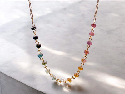 Gorgeous rainbow tourmaline rondelle beaded necklace that is wire wrapped toa 14k gold filled paperclip chain. Handmade and handcrafted natural gems