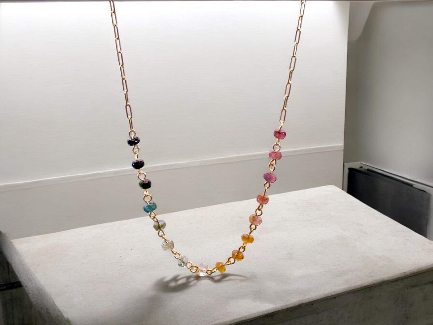 Gorgeous rainbow tourmaline rondelle beaded necklace that is wire wrapped toa 14k gold filled paperclip chain. Handmade and handcrafted natural gems