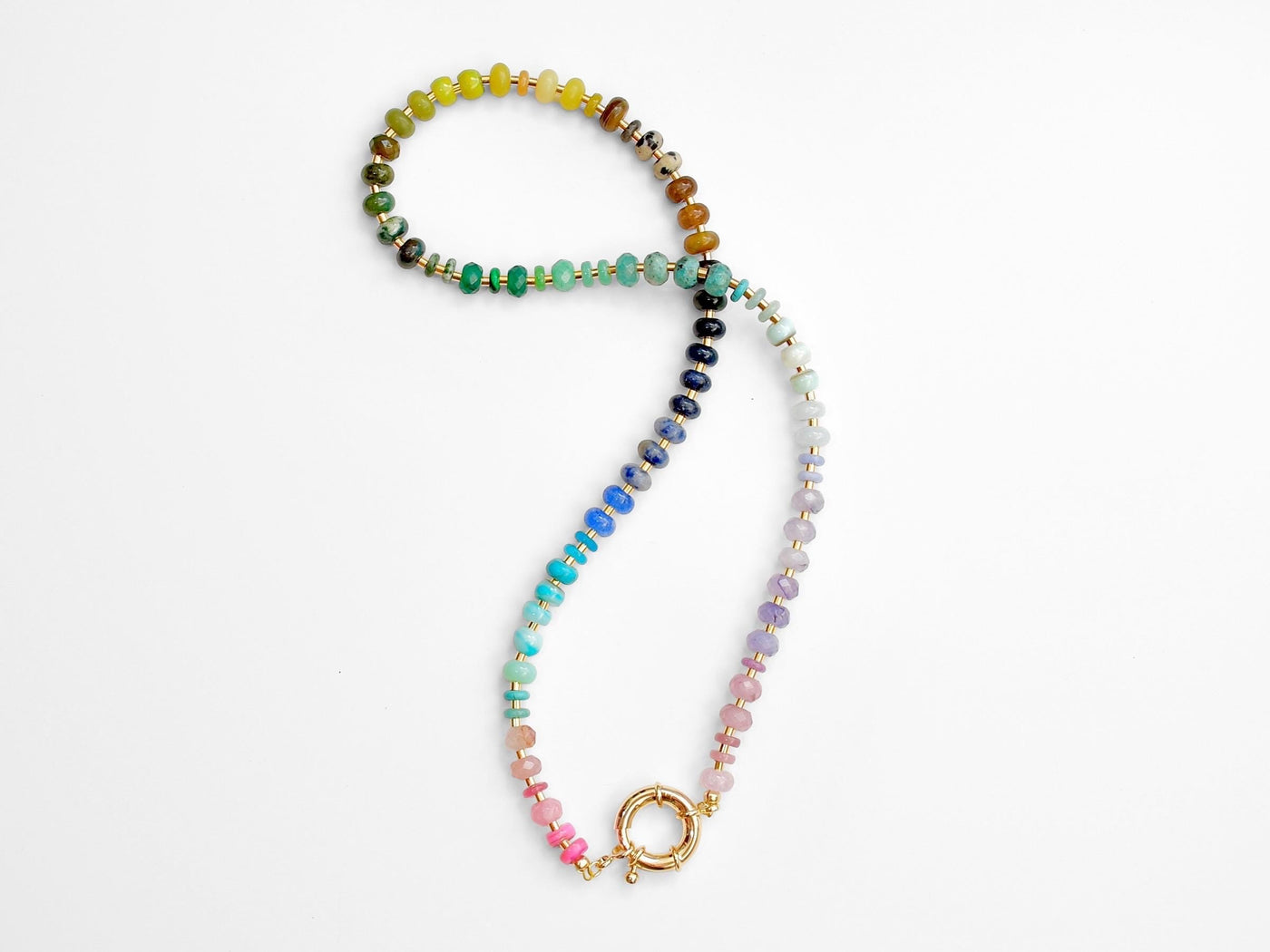 This multi gemstone necklace is handmade, featuring an array of vibrant, rainbow gemstones. From rich amethysts and fiery citrines to lush jades and serene chalcedony.