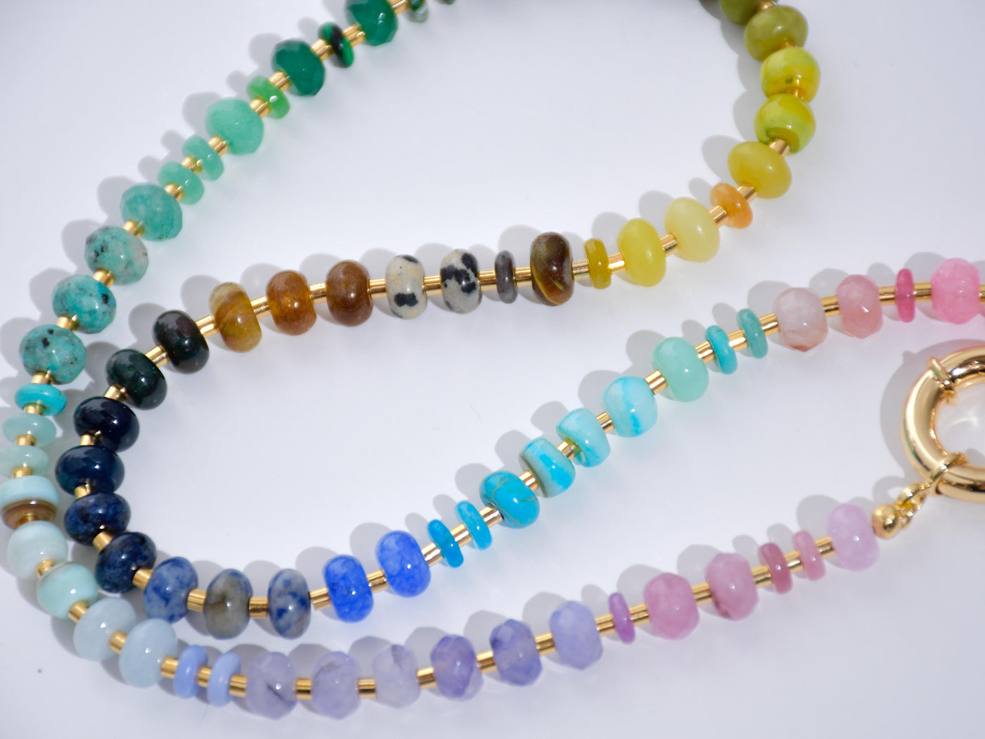 This multi gemstone necklace is handmade, featuring an array of vibrant, rainbow gemstones. From rich amethysts and fiery citrines to lush jades and serene chalcedony.