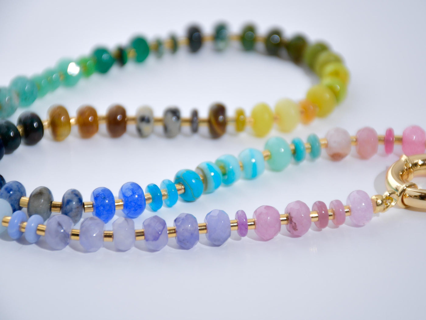 This multi gemstone necklace is handmade, featuring an array of vibrant, rainbow gemstones. From rich amethysts and fiery citrines to lush jades and serene chalcedony.