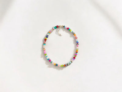 A fun rainbow gemstone necklace in a random assortment. The colors are bright and vibrant. It features 14k gold spacer beads randomly throughout. It’s a beautiful statement necklace to add some color and fun to any outfit. It fits like a choker