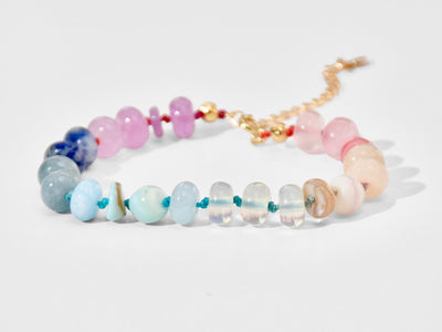 A beautiful pastel colored gemstone hand-knotted bracelet. Hues are rainbow pastels. Natural gemstones hand-knotted with a rainbow ombre thread. It&#39;s perfect to wear alone or stack with other bracelets.