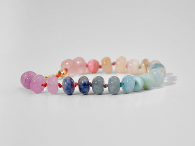 A beautiful pastel colored gemstone hand-knotted bracelet. Hues are rainbow pastels. Natural gemstones hand-knotted with a rainbow ombre thread. It&#39;s perfect to wear alone or stack with other bracelets.