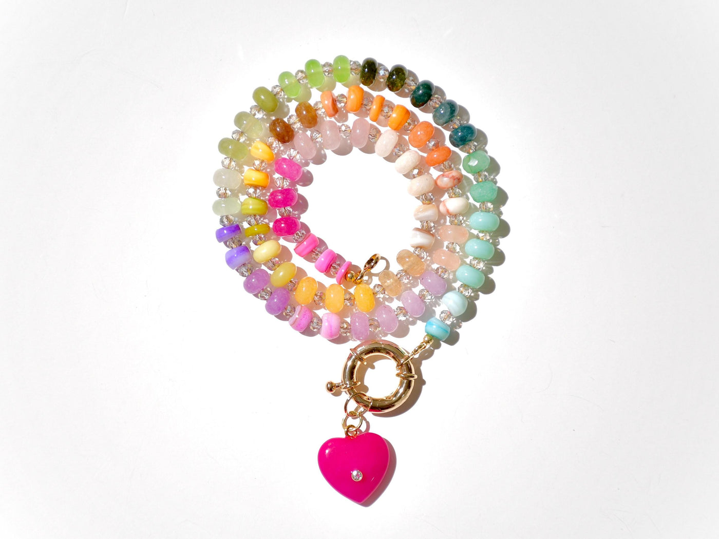 A rainbow multi-gemstone opal necklace that is hand-knotted Made from natural semi precious opal gemstones it features a hot pink heart pendant. It&#39;s feminine & girly w/ a hint of iridescence w/ the added glass shiny beads in between each gemstone.