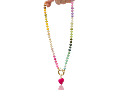 A rainbow multi-gemstone opal necklace that is hand-knotted Made from natural semi precious opal gemstones it features a hot pink heart pendant. It’s feminine & girly w/ a hint of iridescence w/ the added glass shiny beads in between each gemstone.