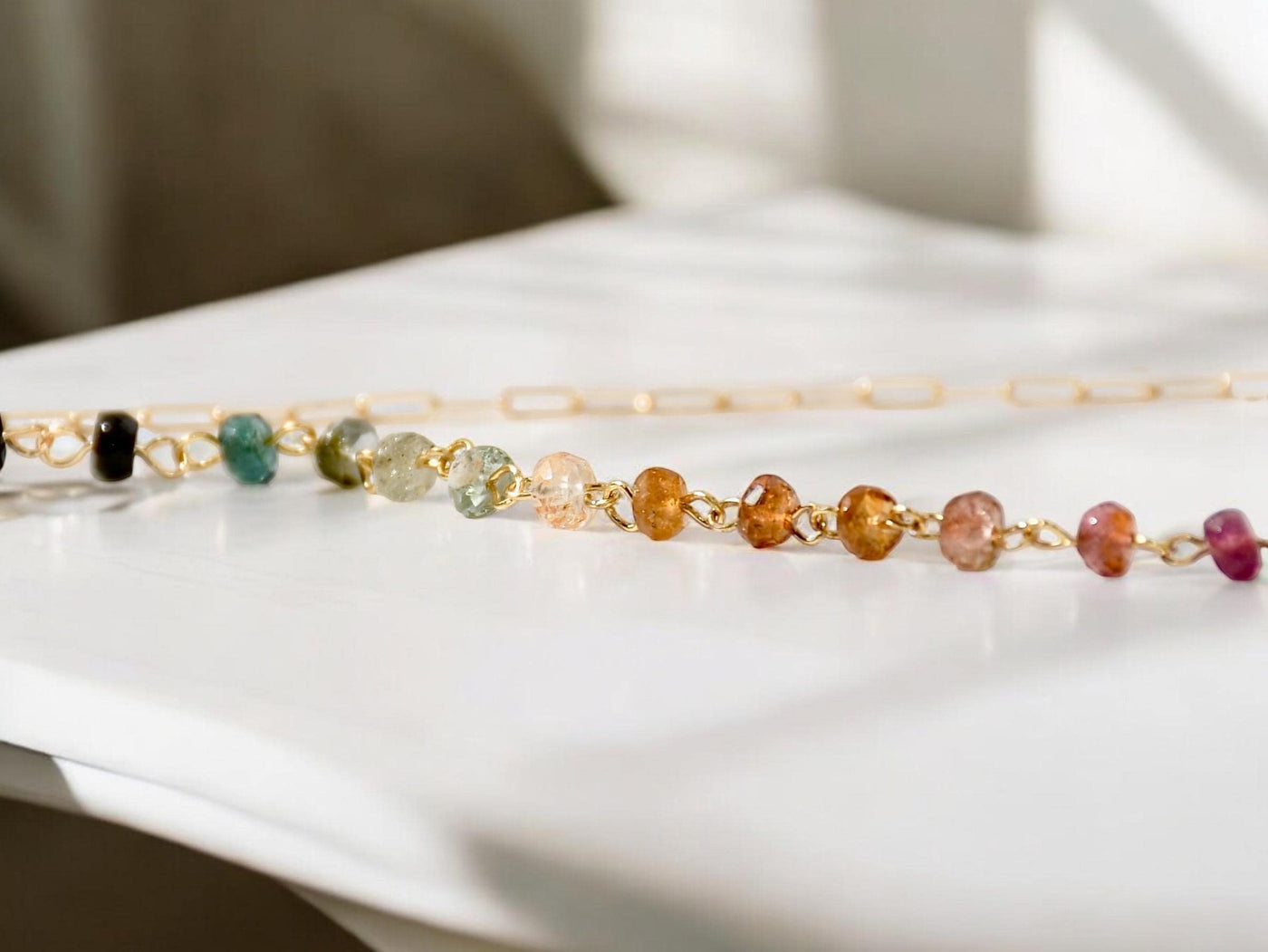 Gorgeous rainbow tourmaline rondelle beaded necklace that is wire wrapped toa 14k gold filled paperclip chain. Handmade and handcrafted natural gems