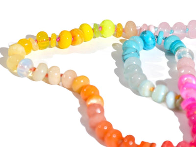 Candy Colored Long Beaded Gem Necklace featuring neon colored rainbow gemstones opal rainbow beads. It is a beautiful Boho Chic Statement Necklace for the Summer in colors of bright neon pinks , purples, oranges, turquoise and yellows.